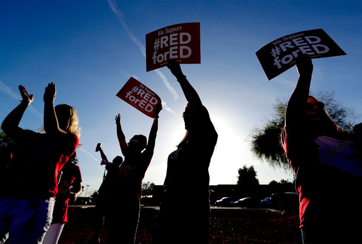 Teachers at Humphrey Elementary school participate in a state-wide walk-in prior to classes Wednesday, April 11, 2018, in Chandler, Ariz.  (AP/Matt York)