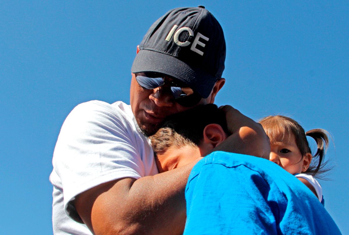 Ivan Castaneda, a former Mexican soldier deported from the United States, embraces his children at the bank of the Rio Grande during the event called "Abrazos No Muros" (Hugs, not walls). (Getty/Herika Martinez)