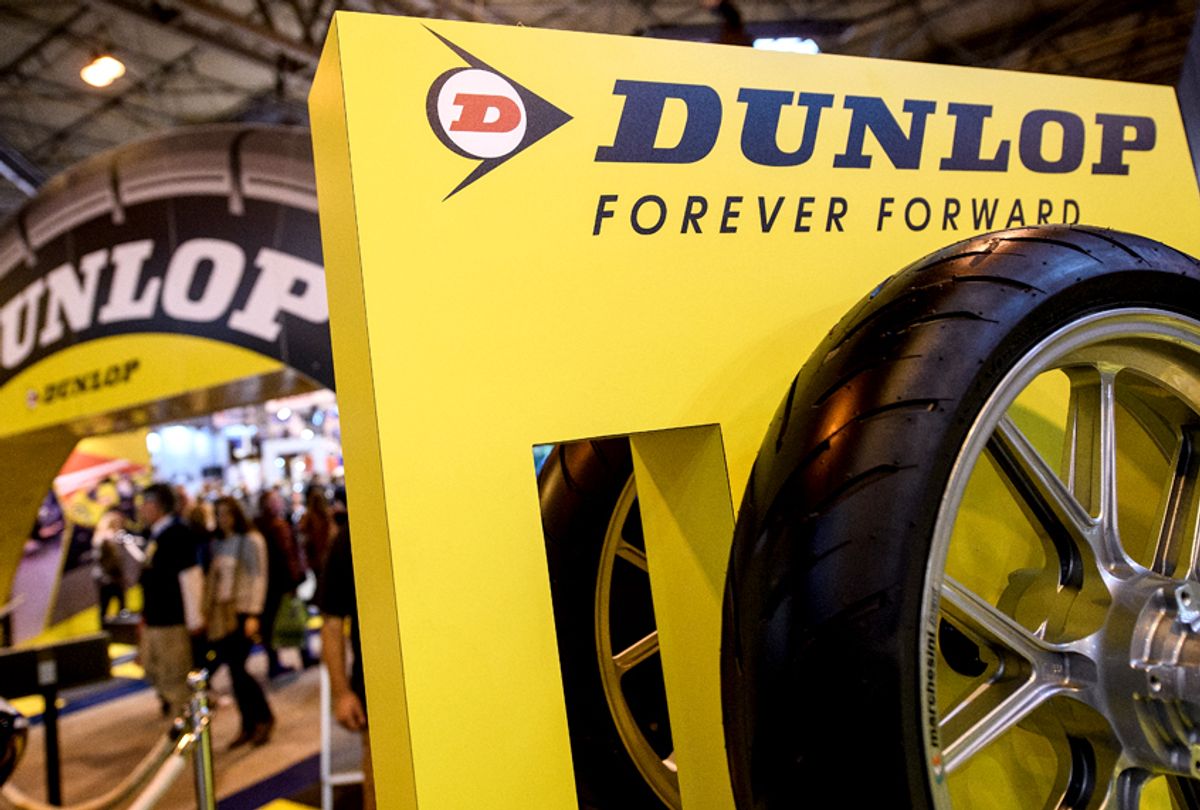 The Dunlop logo and a tire are seen on a stand at the "Motorcycle Live" show. (Getty/Leon Neal)