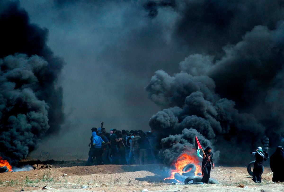 Palestinians clash with Israeli forces near the border between the Gaza strip and Israel, east of Gaza City following the the controversial move to Jerusalem of the United States embassy on May 14, 2018,  (Getty/Thomas Coex)