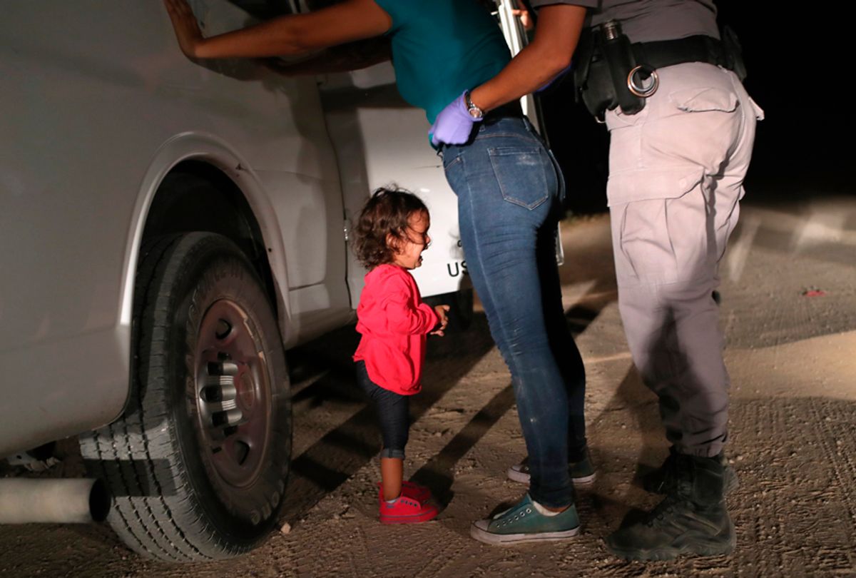 A two-year-old Honduran asylum seeker cries as her mother is searched and detained near the U.S.-Mexico border on June 12, 2018 in McAllen, Texas. (Getty/John Moore)