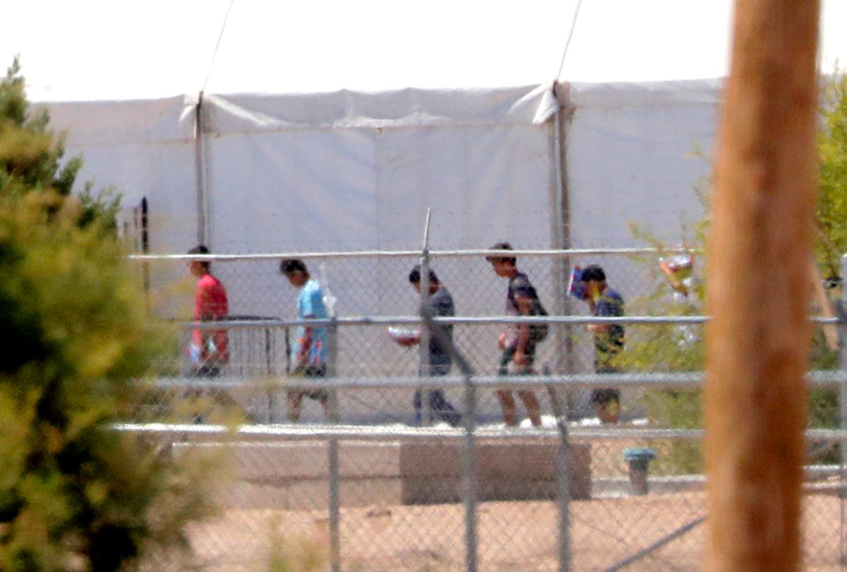 Detainees are seen outside tent shelters used to hold separated family members in Fabens, Texas. (AP/Matt York)