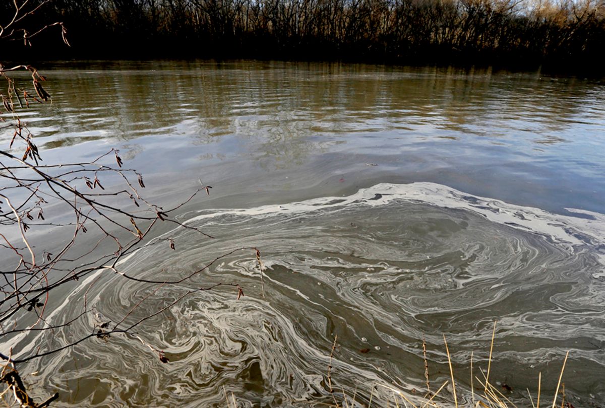 Signs of coal ash swirl in the water in the Dan River after the Duke Energy coal ash spill. (AP/Gerry Broome)