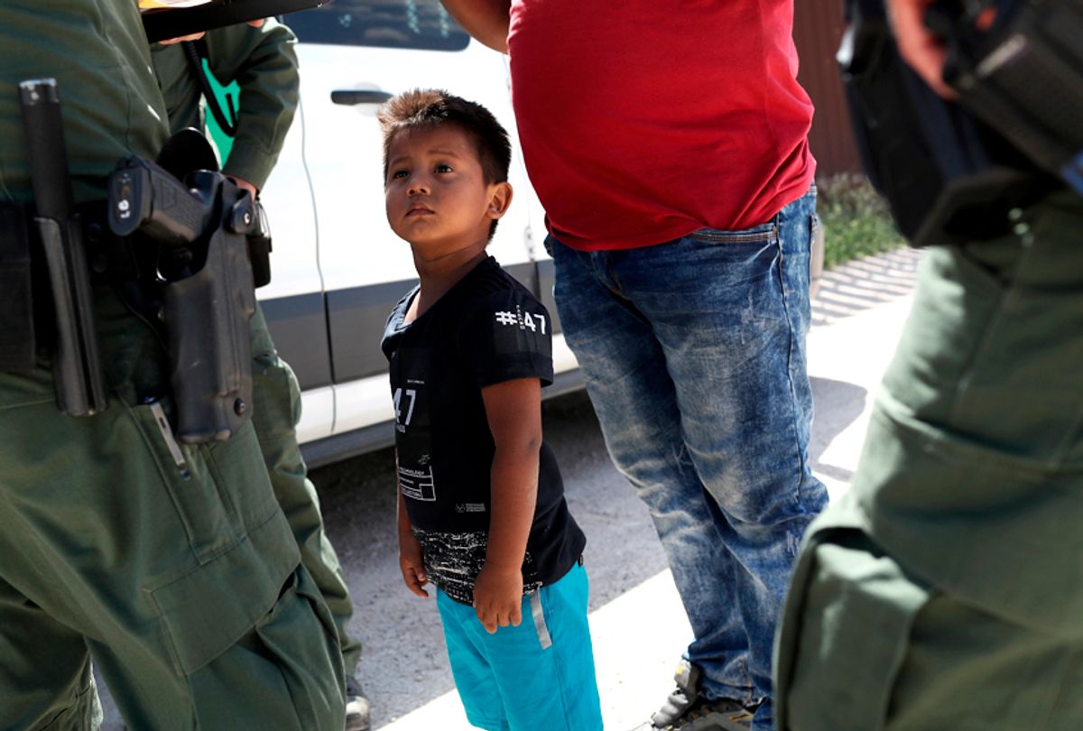 A boy and father from Honduras are taken into custody by U.S. Border Patrol agents near the U.S.-Mexico Border. (Getty/John Moore)