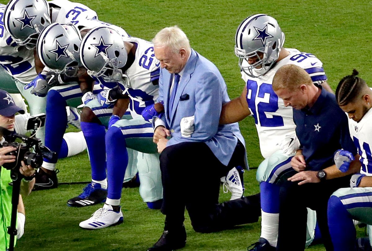 The Dallas Cowboys, led by owner Jerry Jones, take a knee prior to the national anthem before an NFL football game. (AP/Matt York)