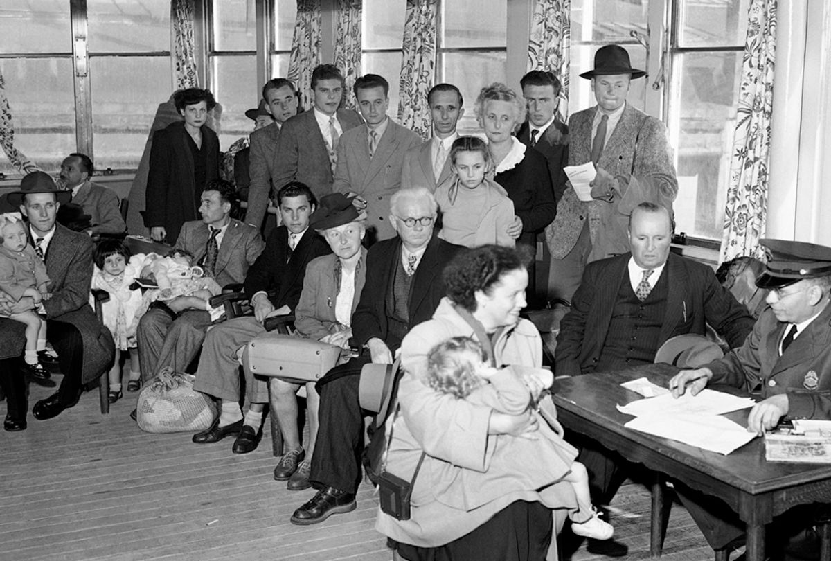 German immigrants are questioned by immigration officers aboard the liner Saturnia on arrival in New York City. They were ordered to Ellis Island for further questioning under the 1950 Security Act. (AP/John Lindsay)