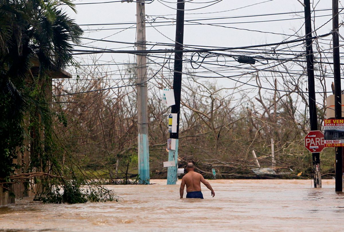 A man wades through a flooded road as Hurricane Maria hits Puerto Rico. (Getty/Ricardo Arduengo)