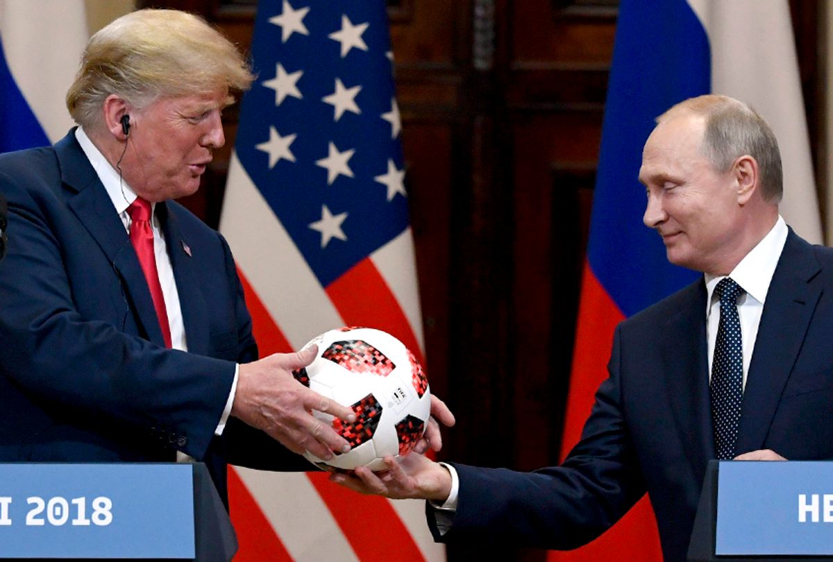 Vladimir Putin presents a soccer ball to Donald Trump during a joint press conference at the Presidential Palace in Helsinki, Finland, Monday, July 16, 2018.  (AP/Jussi Nukari/Lehtikuva)