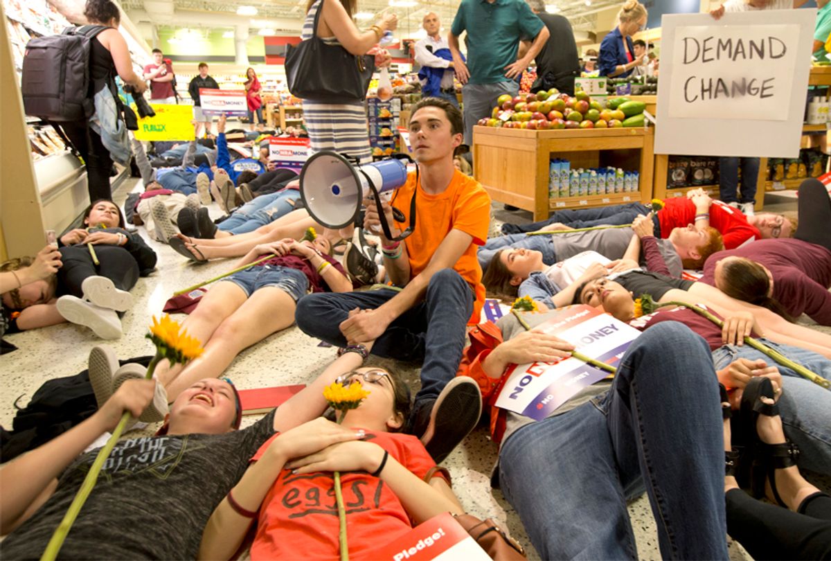 David Hogg and other demonstrators lie on the floor at a Publix Supermarket in Coral Springs, Fla., May 25, 2018.  (AP/Wilfredo Lee)
