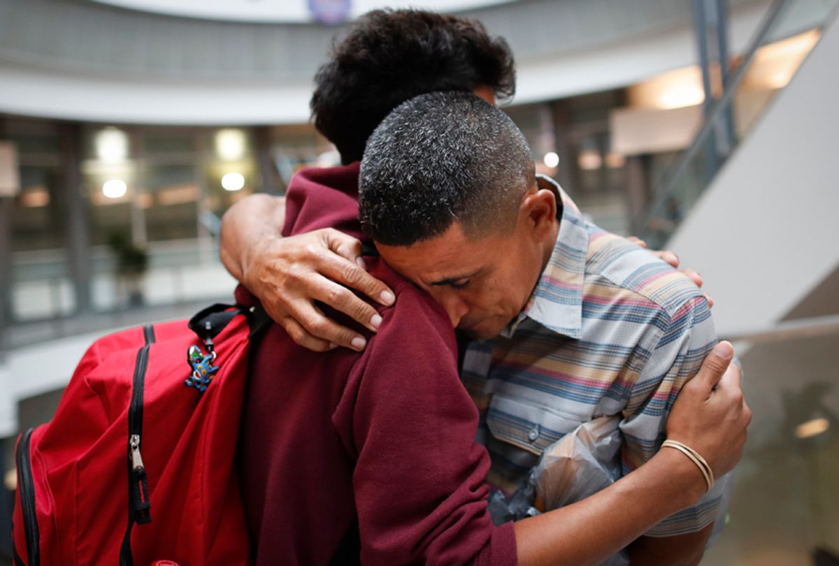 Edvin Cazun, of Guatemala, right, hugs his son Samuel as they reunite after being separated about a month, July 23, 2018, in Hebron, Ky. (AP/John Minchillo)