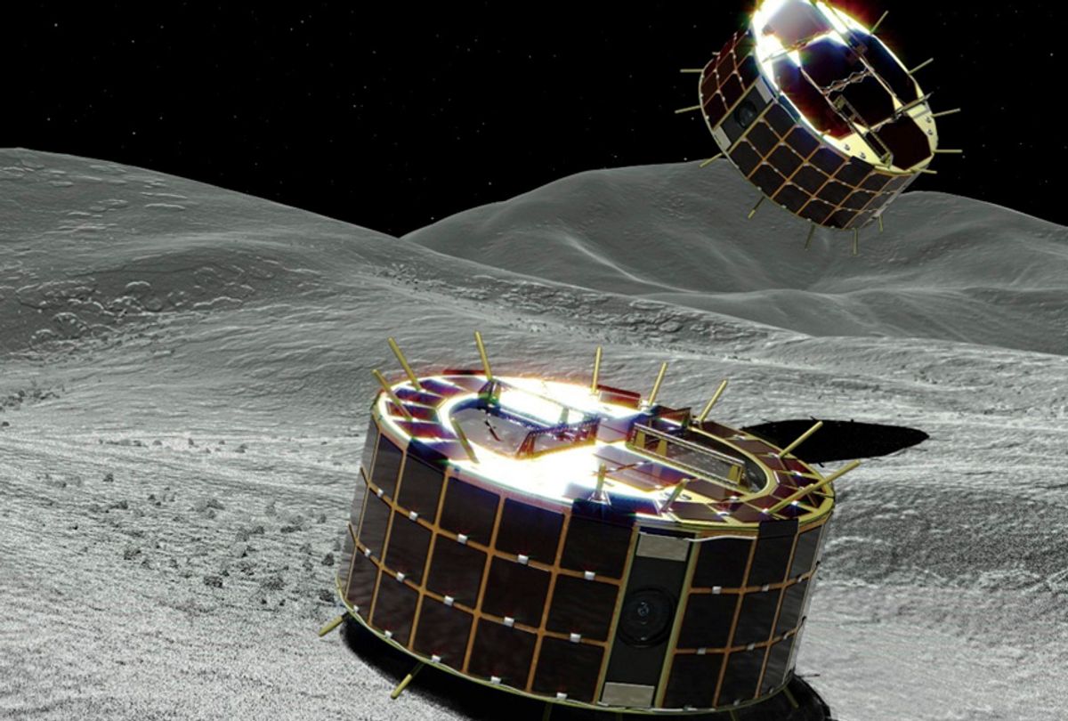 This computer graphic image provided by the Japan Aerospace Exploration Agency (JAXA) shows two drum-shaped and solar-powered Minerva-II-1 rovers on an asteroid. Japanese unmanned spacecraft Hayabusa2 released two small Minerva-II-1 rovers on the asteroid Ryugu on Friday, Sept. 21, 2018. (JAXA via AP)