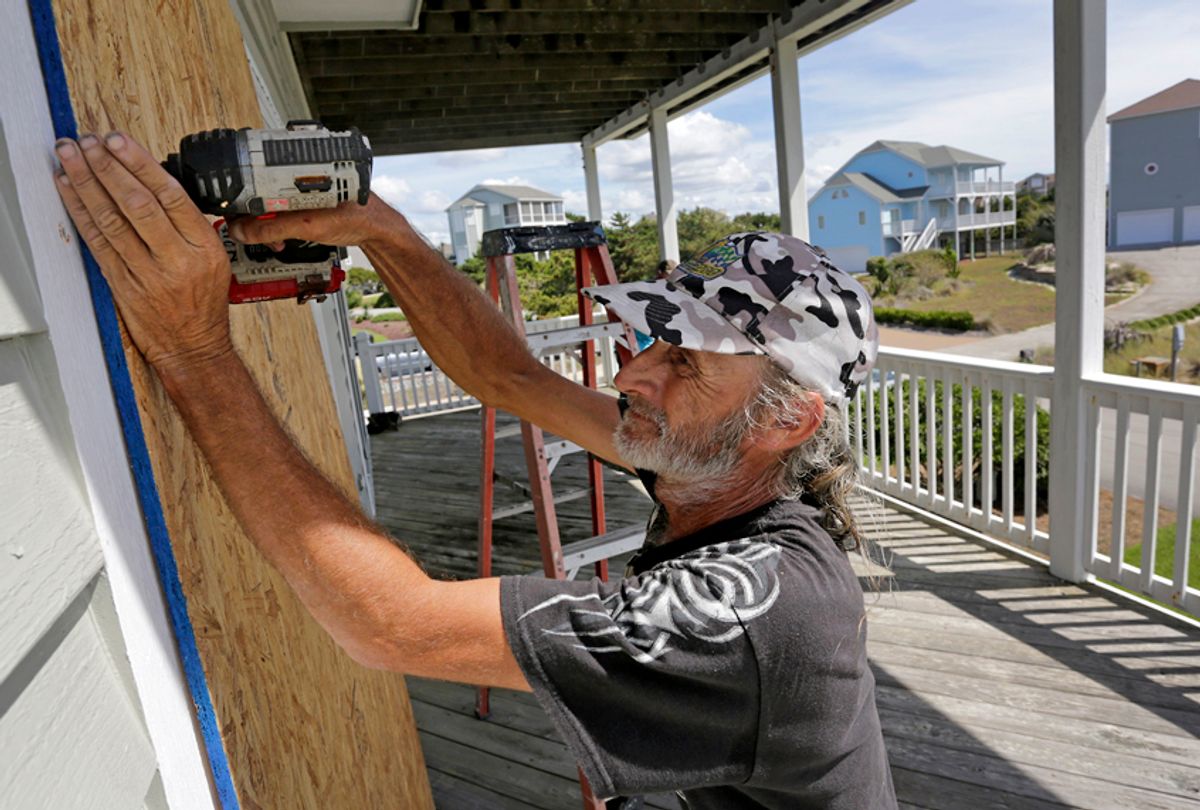 Joe Gore prepares for Hurricane Florence as he boards up windows on a home in Emerald Isle, N.C., Sept. 12, 2018. (AP/Tom Copeland)