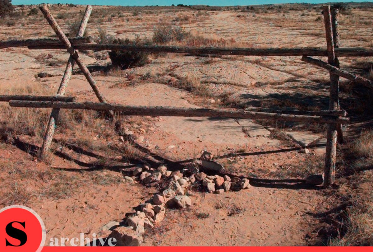 In this Oct. 9, 1999 file photo a cross made of stones rests below the fence in Laramie, Wyo. where gay University of Wyoming college student Matthew Shepard was beaten and left for dead. (AP/Ed Andrieski)