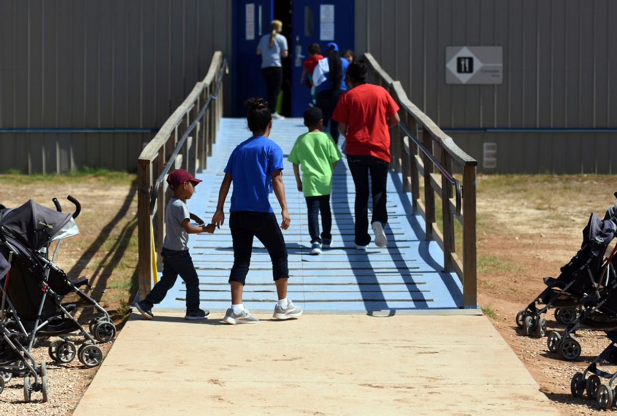 Immigrants walk into a building at South Texas Family Residential Center in Dilley, Texas on Aug. 9, 2018. (Charles Reed/U.S. Immigration and Customs Enforcement via AP)