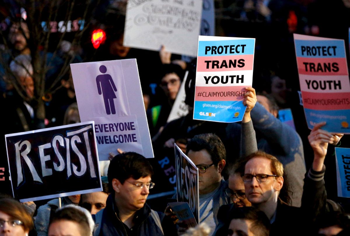 Protesters hold signs at a rally in support of transgender youth, Thursday, Feb. 23, 2017, at the Stonewall National Monument in New York. (AP/Kathy Willens)