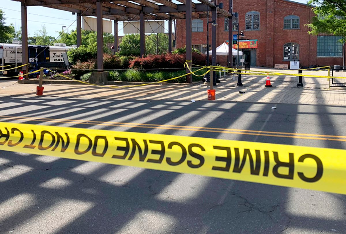Police crime-scene tape keeps people away from the brick Roebling Wire Works building, background, in Trenton, N.J., hours after a shooting broke out there at an all-night art festival June 17, 2018. (AP/Mike Catalini)