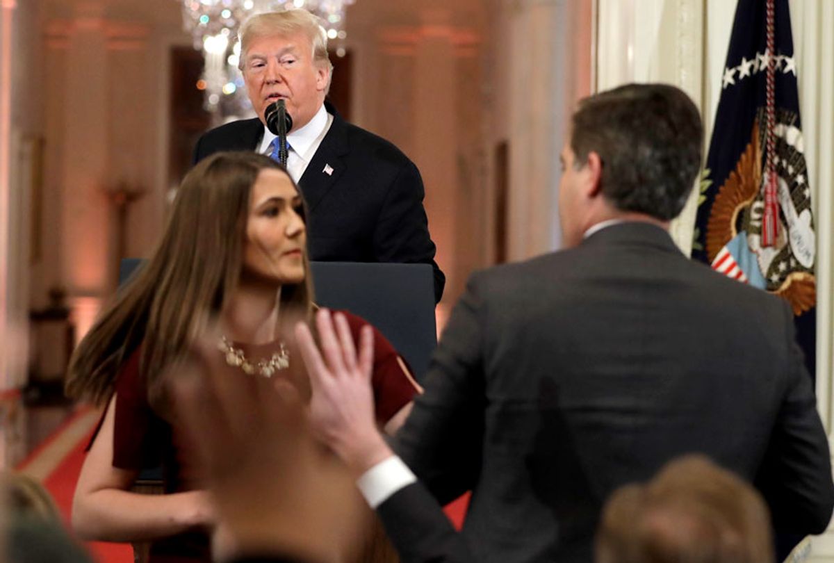 A White House aide takes the microphone from CNN's Jim Acosta, during a news conference in the East Room of the White House, Wednesday, Nov. 7, 2018. A doctored video of this incident went viral.  (AP/Evan Vucci)