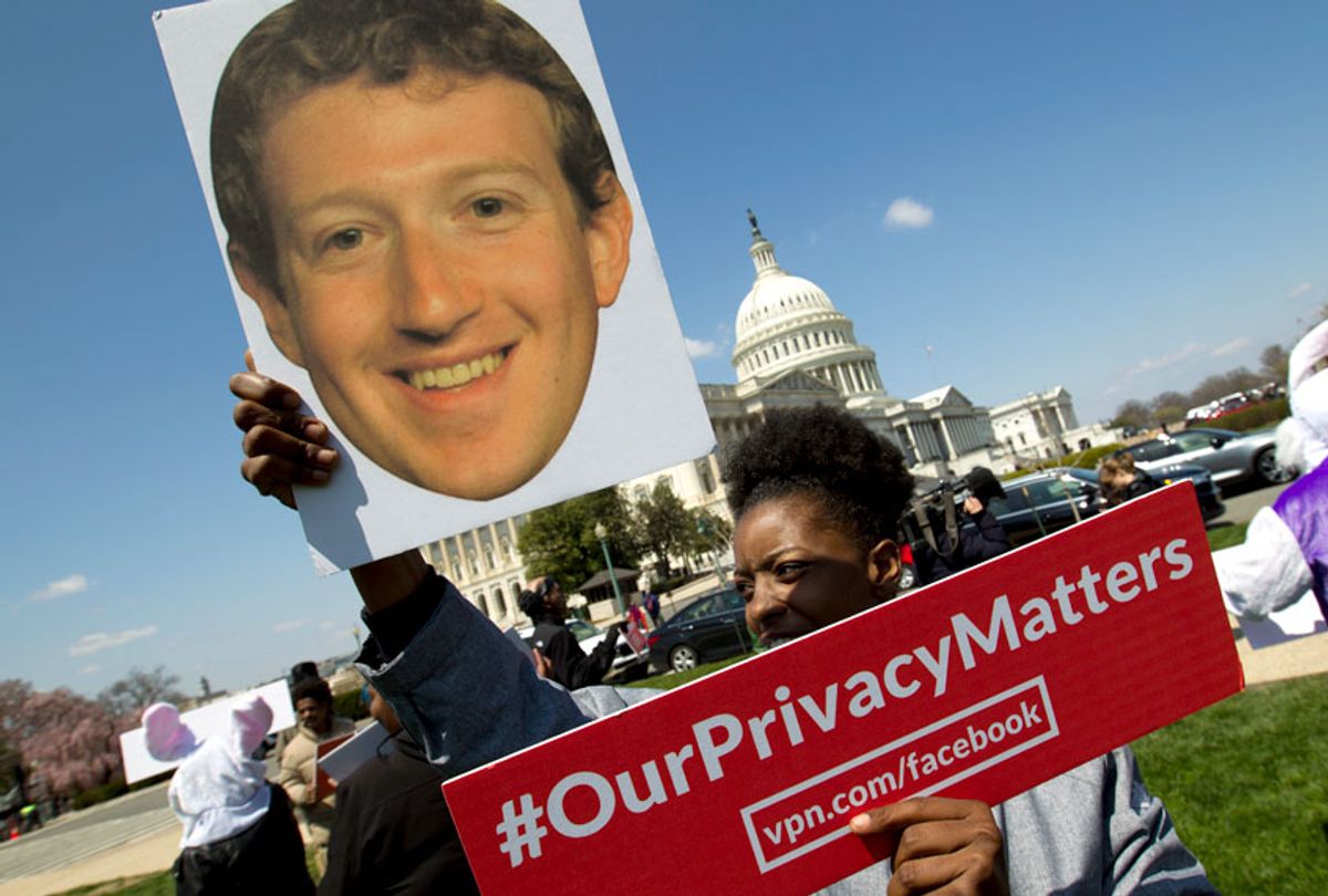 Demonstrator holding up a photo of Facebook CEO Mark Zuckerberg protest outside of the U.S. Capitol. (AP/Jose Luis Magana)