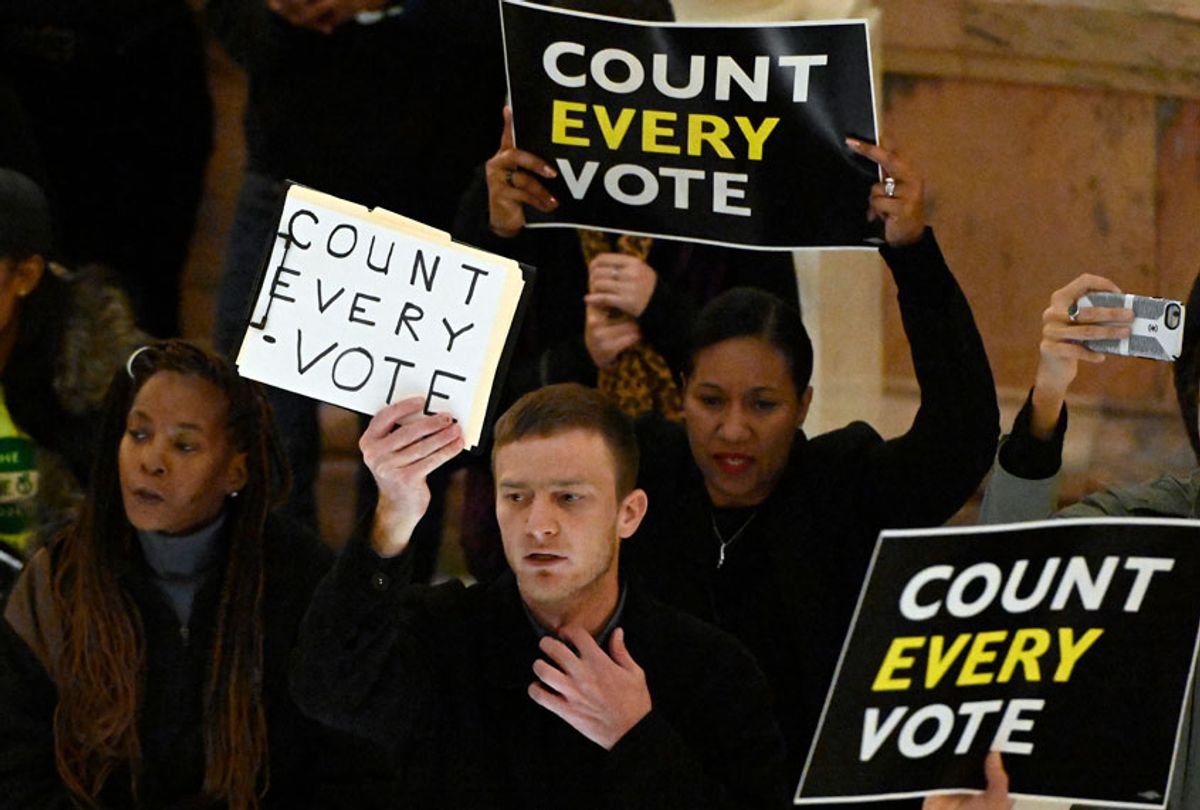 People hold signs as they protest the election in the rotunda of the state capitol building Tuesday, Nov. 13, 2018, in Atlanta (AP/John Bazemore)