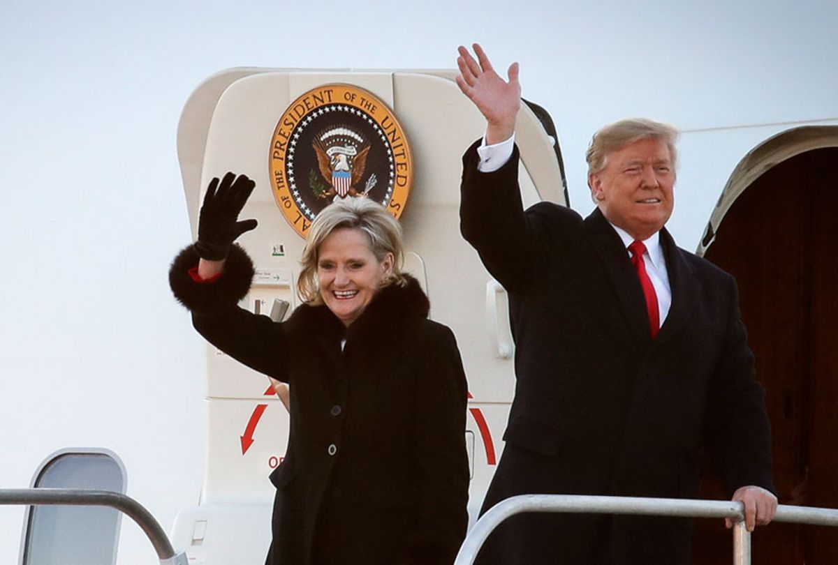 Cindy Hyde-Smith and Donald Trump wave as they exit Air Force One as they arrive for a rally at the Tupelo Regional Airport, November 26, 2018 in Tupelo, Mississippi. (Getty/Drew Angerer)