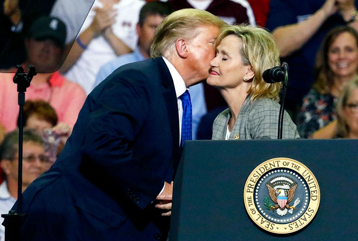 Donald Trump kisses U.S. Sen. Cindy Hyde-Smith, R-Miss., after introducing her at a rally in Southaven, Miss. (AP/Rogelio V. Solis)