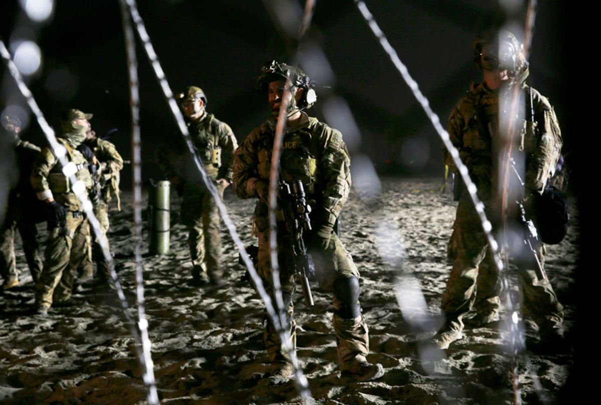 U.S. Border Patrol agents stand on the U.S. side of the border. (AP/Marco Ugarte)