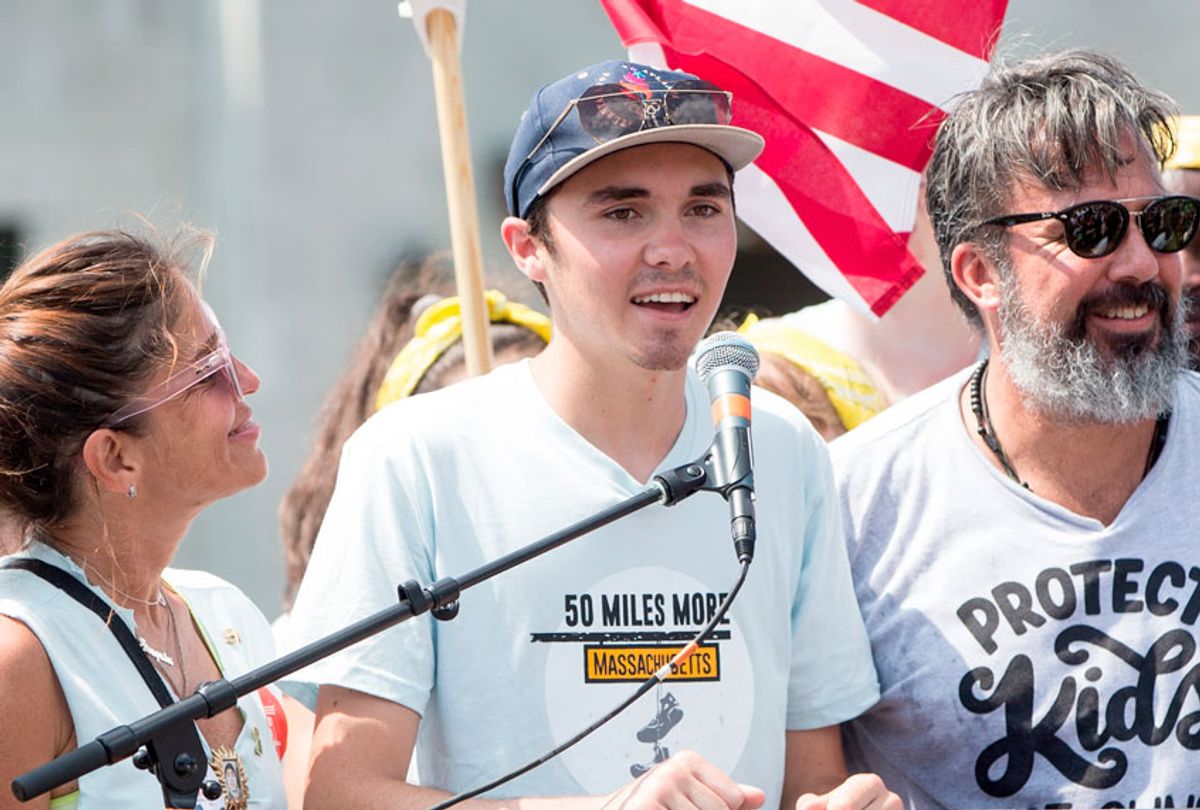 Parkland shooting victim and survior David Hogg; center, joins Manuel Oliver and his wife Patricia Oliver, parents of Parkland shooting victim Joaquin Oliver, and other members of the 50 Miles More walk against gun violence rally at the end of their walk on August 26, 2018 in Springfield, Massachusetts.  (Getty/Scott Eisen)