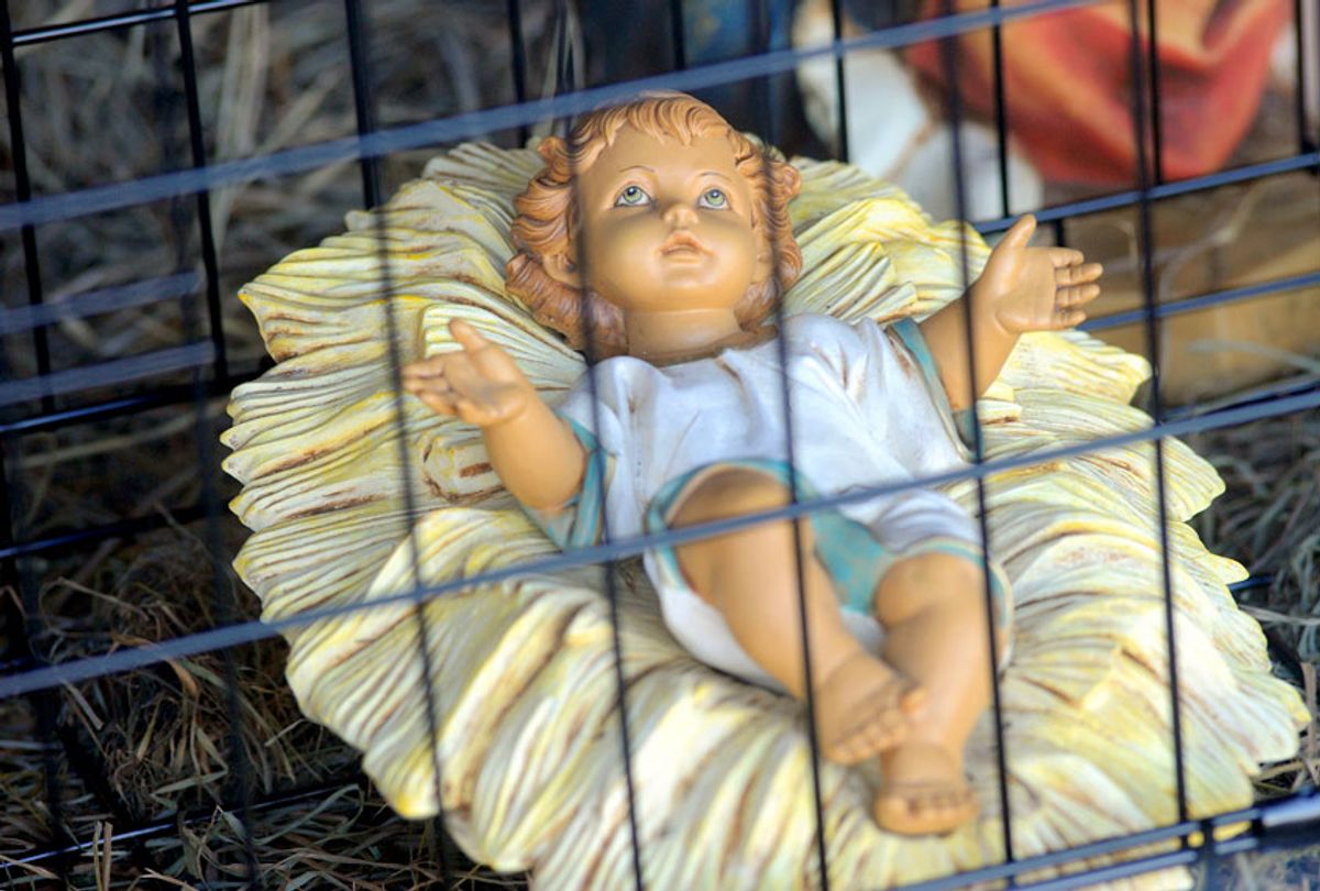 A close-up of a nativity scene depicting baby Jesus in a jail cell and the three wiseman behind a border fence stands outside at Saint Susanna Parish in Dedham, Massachusetts on December 9, 2018. (Getty/Joseph Prezioso)