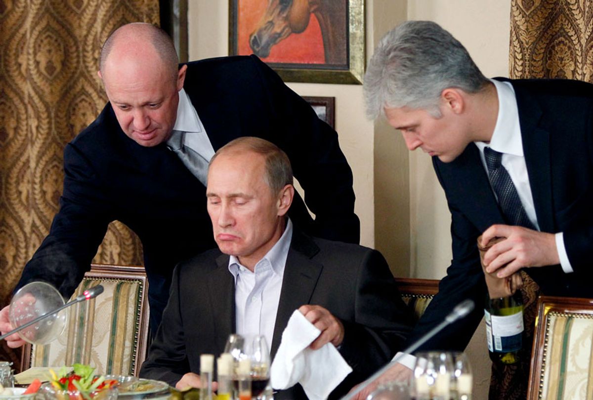 Yevgeny Prigozhin, left, serves food to Vladimir Putin during dinner at Prigozhin's restaurant outside Moscow, Russia, Friday, Nov. 11, 2011. (AP/Misha Japaridze)