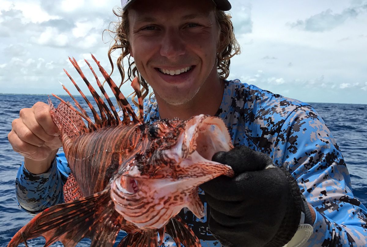 Forever Young Charter Company captain Tony Young, holding a lionfish.  (Courtesy of Forever Young/Civil Eats)