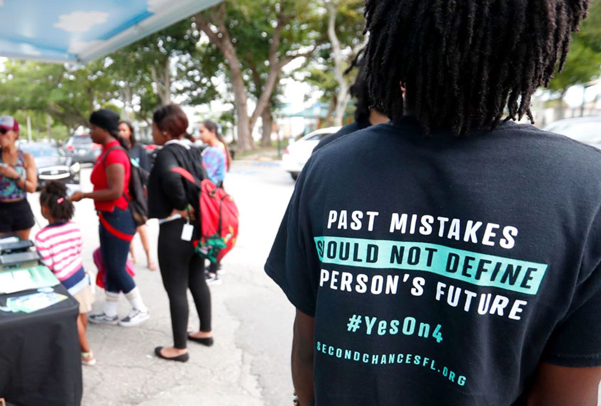 people gather around the Ben & Jerry's "Yes on 4" truck as they learn about Amendment 4 and eat free ice cream at Charles Hadley Park in Miami on Oct. 22, 2018. (AP/Wilfredo Lee)