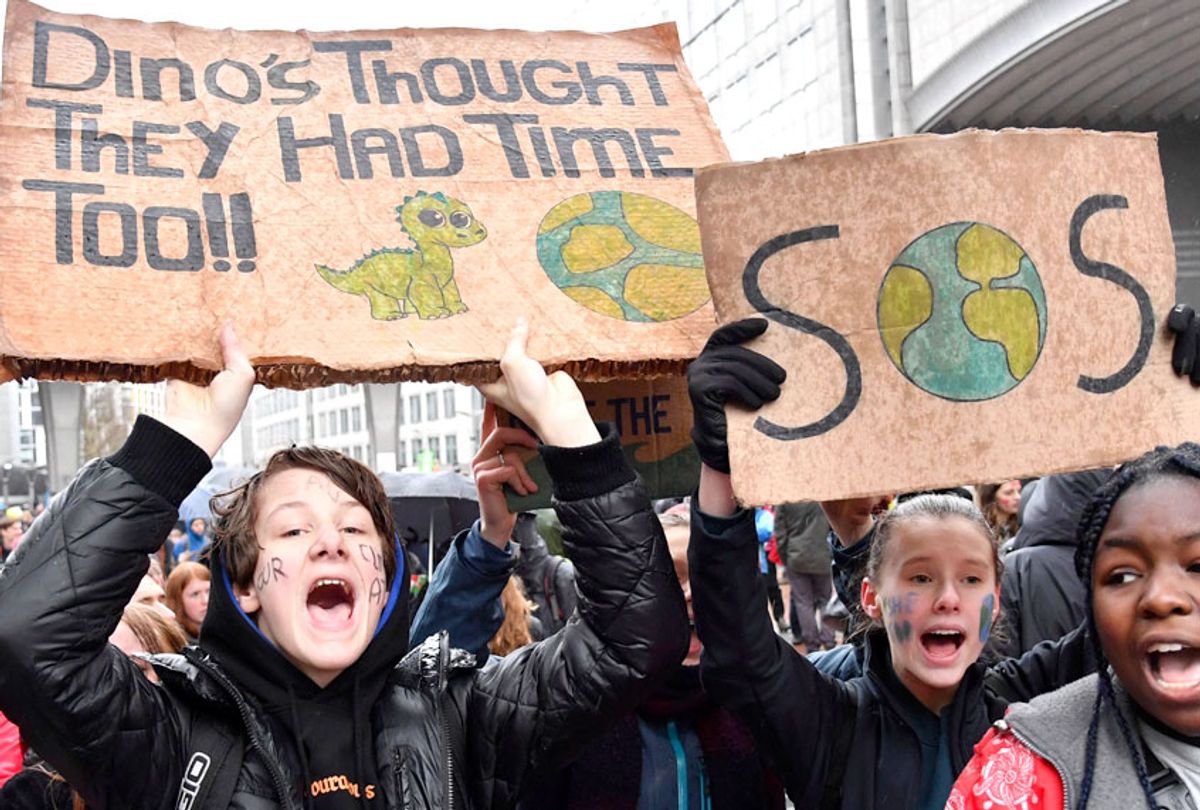Protestors hold placards as they march during a Rise for the Climate demonstration in Brussels, Sunday, Jan. 27, 2019. (AP/Geert Vanden Wijngaert)