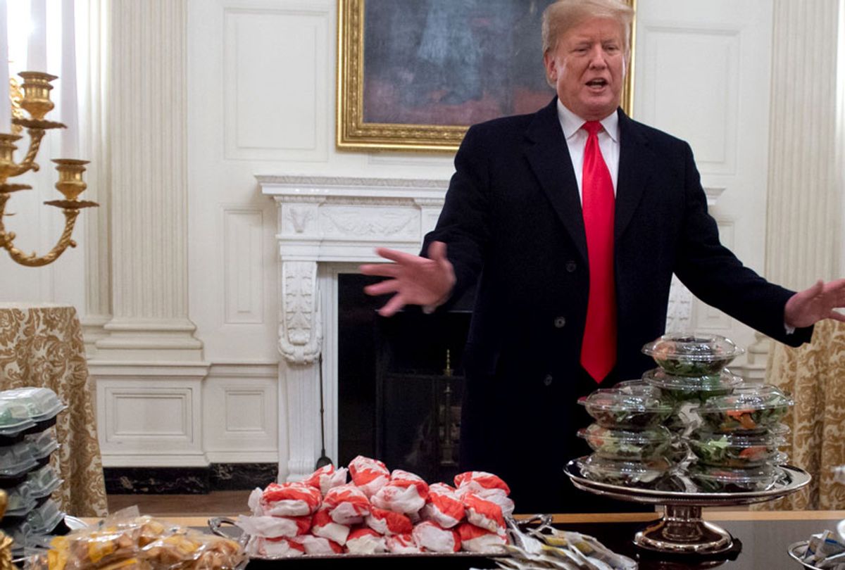 Donald Trump speaks alongside fast food he purchased for a ceremony honoring the 2018 College Football Playoff National Champion Clemson Tigers in the State Dining Room of the White House in Washington, DC, January 14, 2019. (Getty/Saul Loeb)