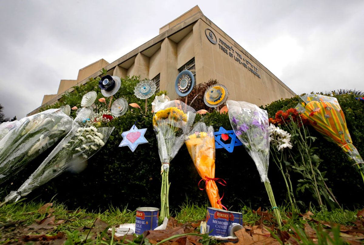 A makeshift memorial of flowers rests on bushes outside the Tree of Life Synagogue in Pittsburgh. (AP/Gene J. Puskar)