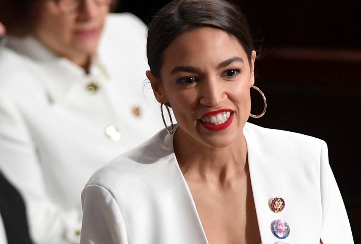 US Representative Alexandria Ocasio-Cortez smiles, dressed in white in tribute to the women's suffrage movement, as she arrives at the State of the Union address at the US Capitol in Washington, DC, on February 5, 2019. (Getty/Saul Loeb)