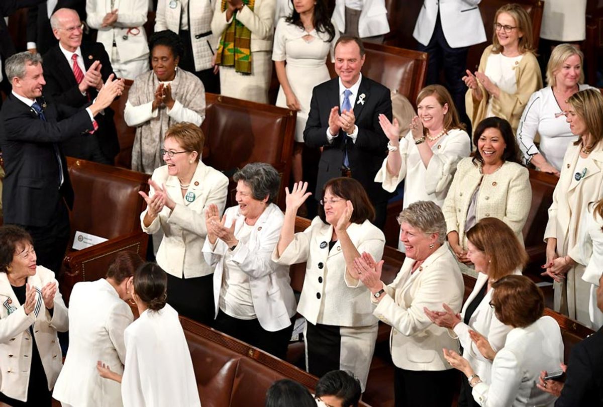 Congresswomen, dressed in white in tribute to the women's suffrage movement, applaud as they attend the State of the Union address at the US Capitol in Washington, DC, on February 5, 2019.  (Getty/Mandel Ngan)
