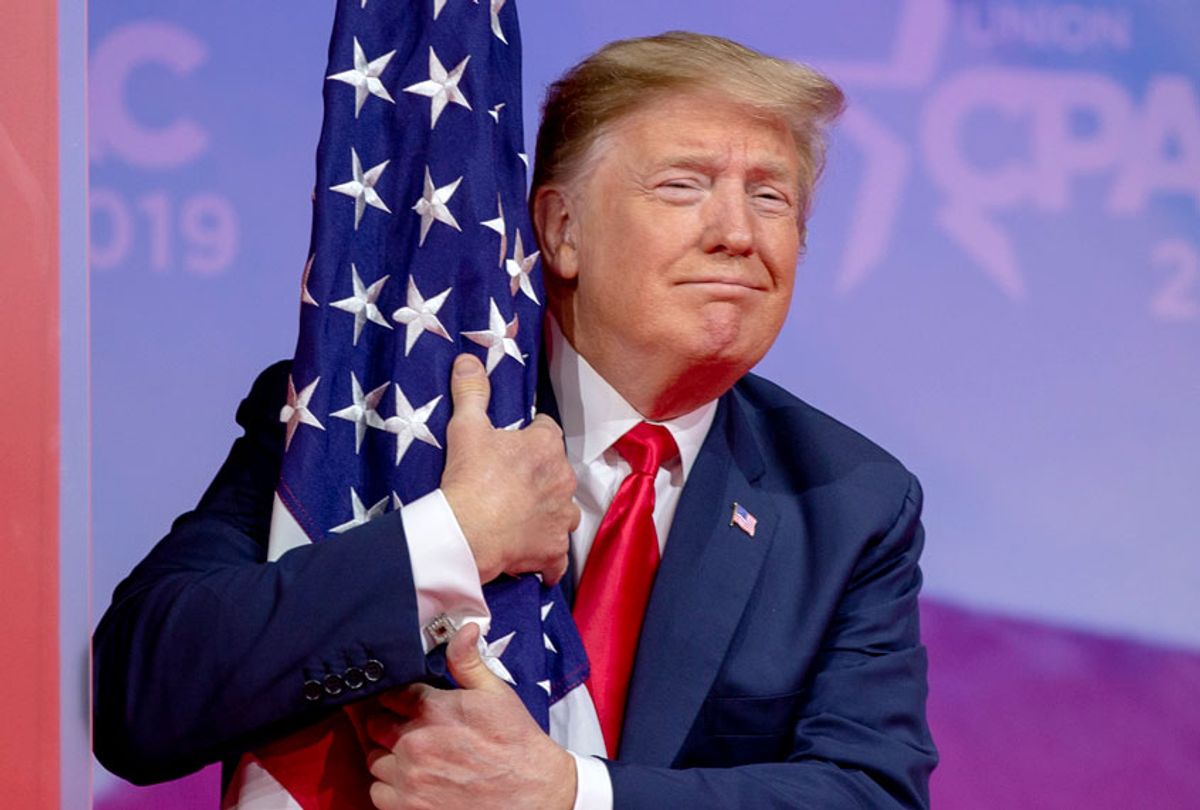Donald Trump hugs the U.S. flag during CPAC 2019 on March 02, 2019 in National Harbor, Maryland. (Getty/Tasos Katopodis)