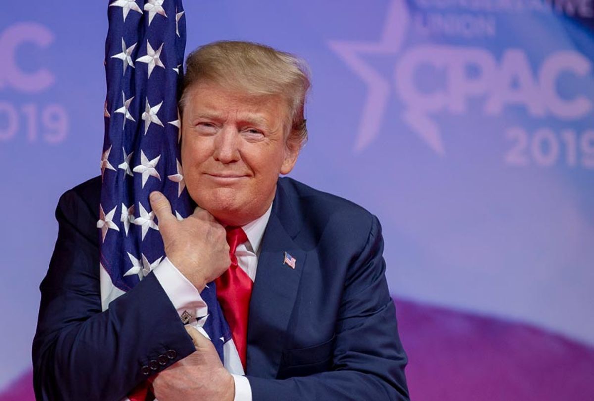 Donald Trump hugs the U.S. flag during CPAC 2019 on March 02, 2019 in National Harbor, Maryland. (Getty/Tasos Katopodis)