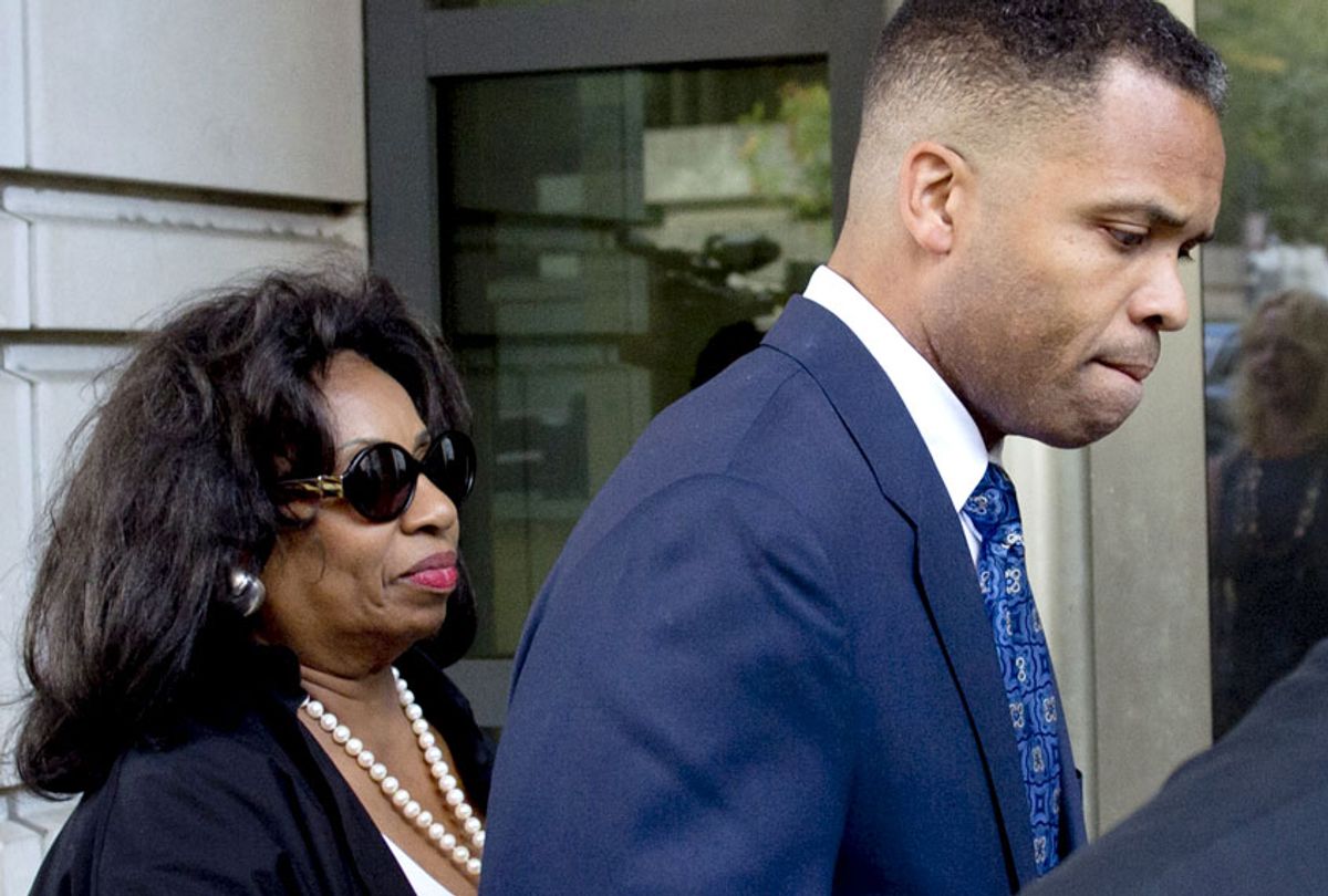 Jesse Jackson Jr., walks with his mother, Jacqueline lavinia Brown, as he leaves the US District Court in Washington, DC, August 14, 2013, following a sentencing hearing. (Getty/Saul Loeb)
