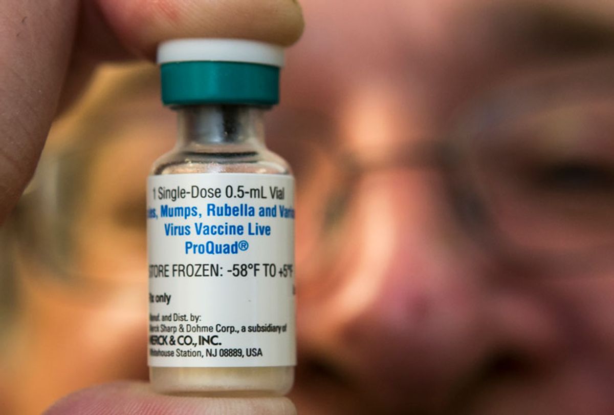 A pediatrician holds a dose of the measles-mumps-rubella (MMR) vaccine at his practice. (AP/Damian Dovarganes)