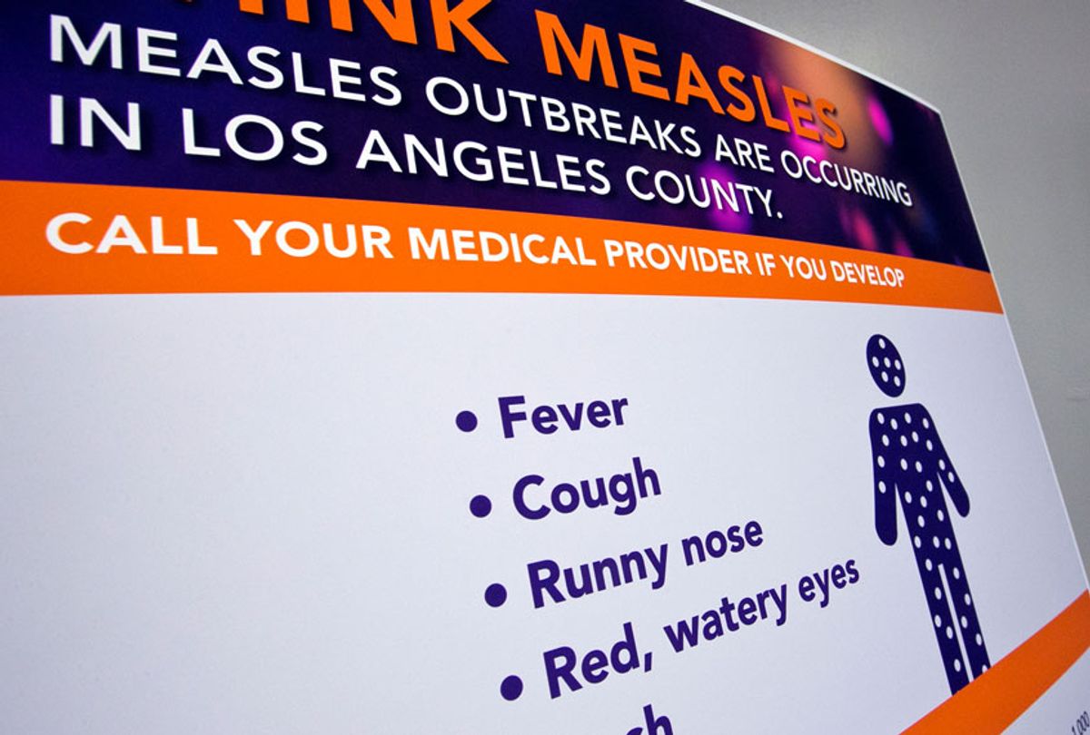 A poster released by Los Angeles County Department of Public Health is seen as experts answer questions regarding the measles response and the quarantine orders in Los Angeles Friday, April 26, 2019. (AP/Damian Dovarganes)