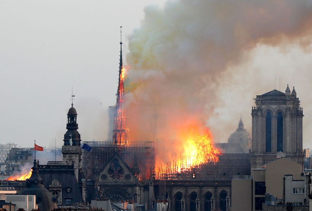 Flames rise from Notre Dame cathedral as it burns in Paris, Monday, April 15, 2019. Massive plumes of yellow brown smoke is filling the air above Notre Dame Cathedral and ash is falling on tourists and others around the island that marks the center of Paris. (AP/Thibault Camus)