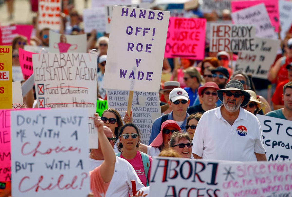 Protesters for women's rights march to the Alabama Capitol to protest a law passed last week making abortion a felony in nearly all cases with no exceptions for cases of rape or incest, Sunday, May 19, 2019, in Montgomery, Ala.  (AP/Butch Dill)