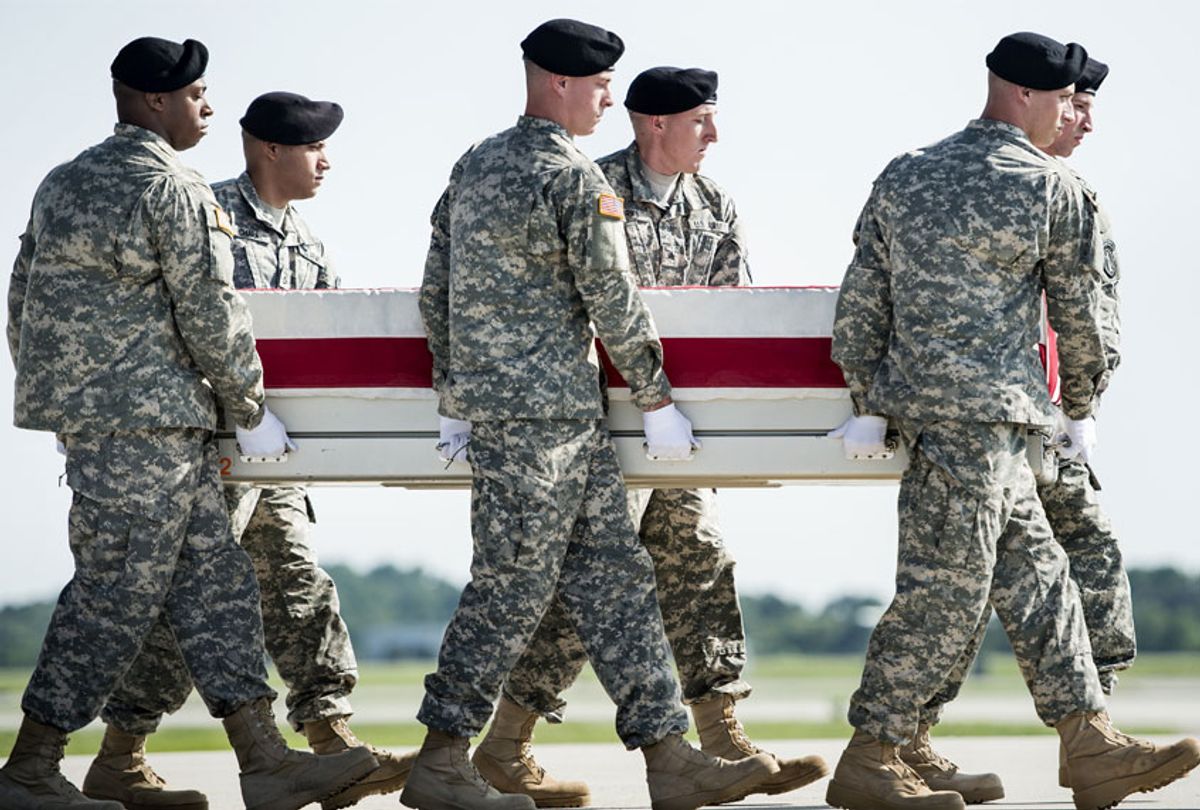 A US Army carry team moves a transfer case with the remains of US Army Maj. Gen. Harold J. Greene from a C-17 cargo plane during a dignified transfer at Dover Air Force Base August 7, 2014 in Delaware. (Getty/Brendan SMIALOWSKI)