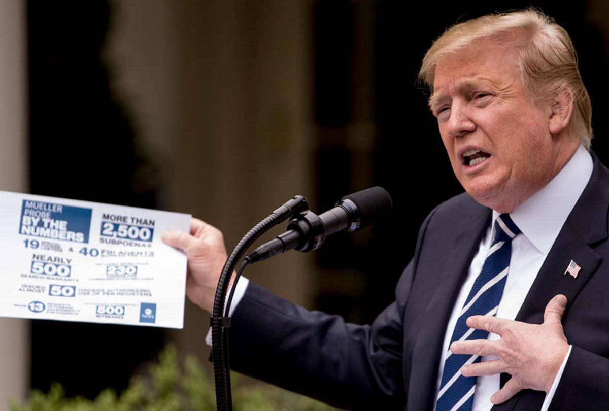 President Donald Trump holds up a stat sheet having to do with the Mueller Report as he speaks in the Rose Garden at the White House in Washington, Wednesday, May 22, 2019. (AP/Andrew Harnik)