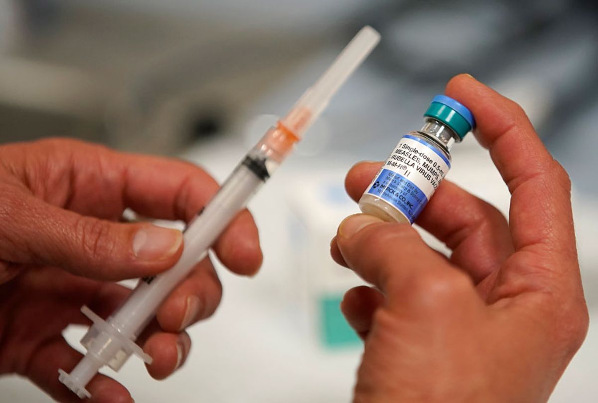 A one dose bottle of measles, mumps and rubella virus vaccine, made by MERCK, is held up at the Salt Lake County Health Department on April 26, 2019 in Salt Lake City, Utah. (Getty/George Frey)