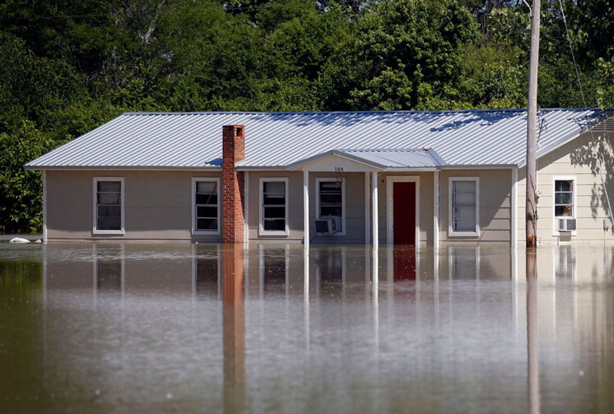 In this Thursday, May 23, 2019 photo, floodwaters overtake a home in Holly Bluff, Mississippi. (AP/Rogelio V. Solis)
