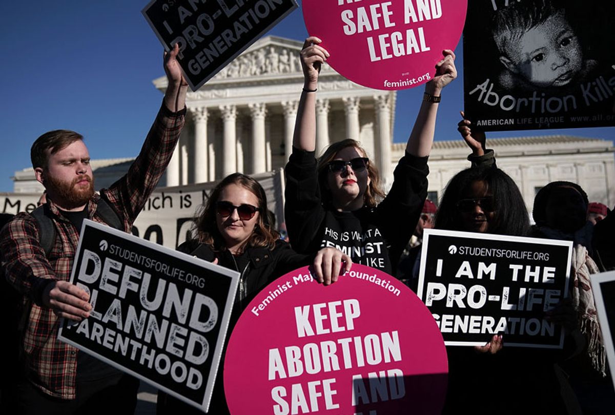 Pro-life activists try to block the signs of pro-choice activists in front of the the U.S. Supreme Court during the 2018 March for Life January 19, 2018 in Washington, DC. (Getty/Alex Wong)