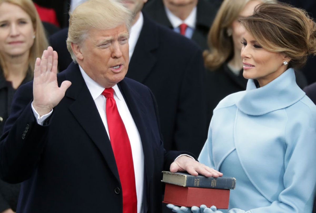 President Donald Trump takes the oath of office as his wife Melania Trump holds the bible on the West Front of the U.S. Capitol on January 20, 2017 in Washington, DC. (Getty/Chip Somodevilla)