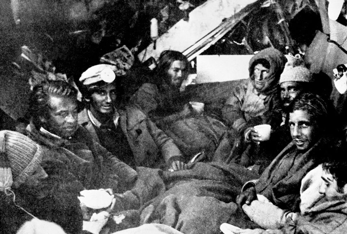 The last eight survivors of the Uruguayan Air Force plane crash in the Andes in South America, huddle together in the craft's fuselage on their final night before rescue on Dec. 22, 1972. (AP Photo)